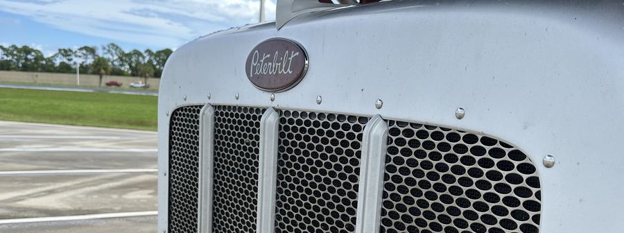 Close-up of a car-hauling truck's grille and hood
